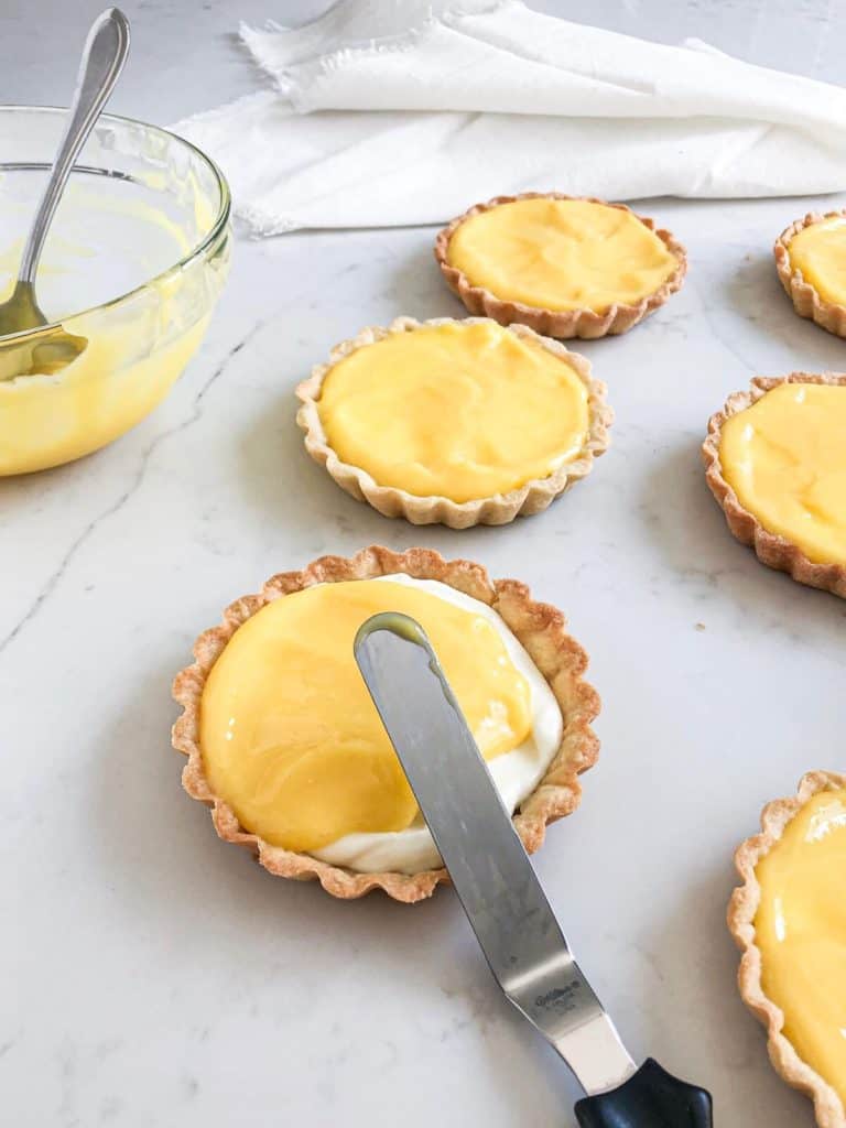 assembling lemon tarts