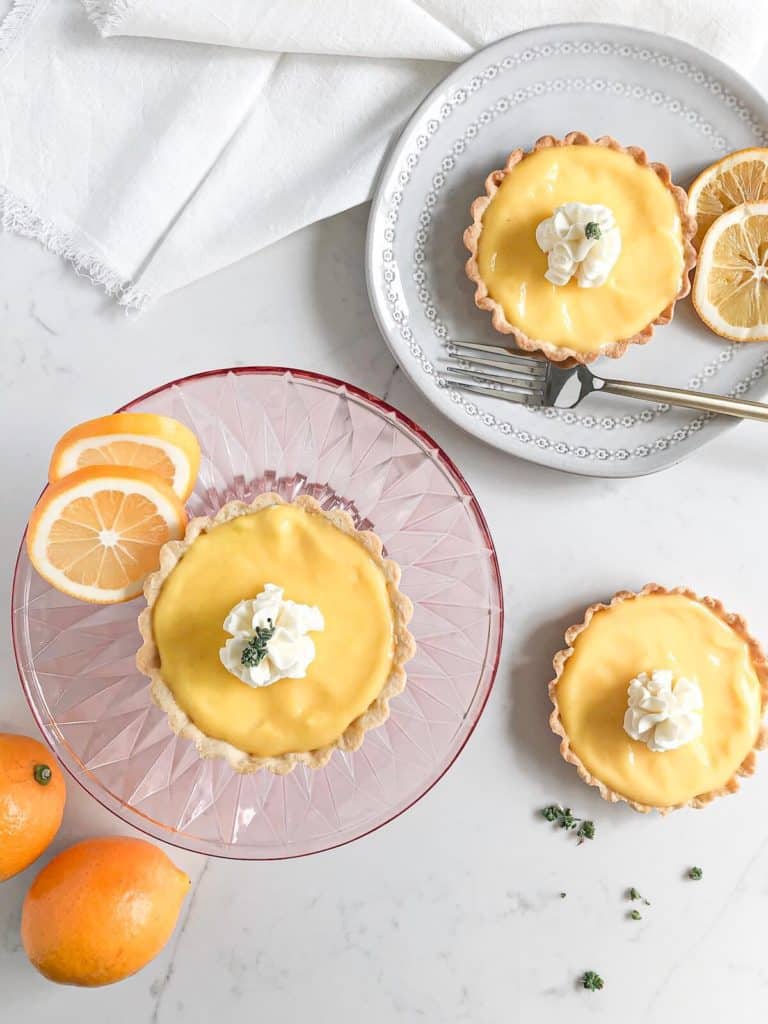 overhead view of lemon tart on plate and cake stand