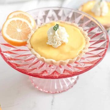 meyer lemon tart on pink cake stand