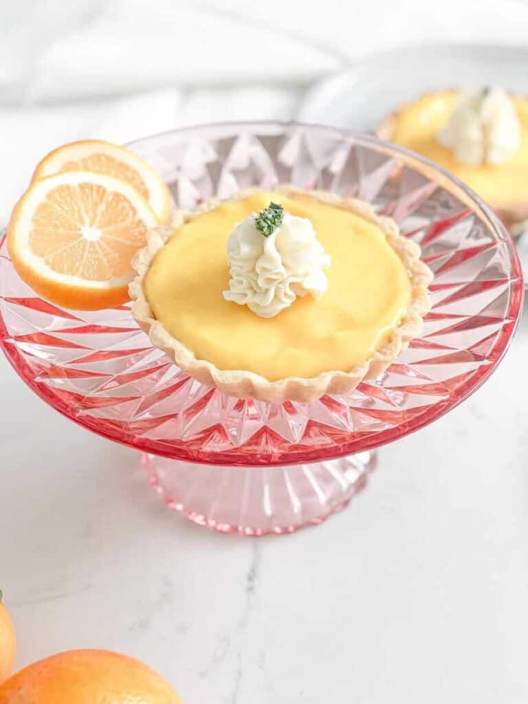 lemon tart on pink cake stand