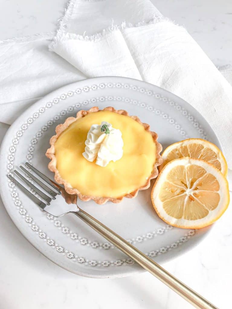 lemon tart on a plate with a fork