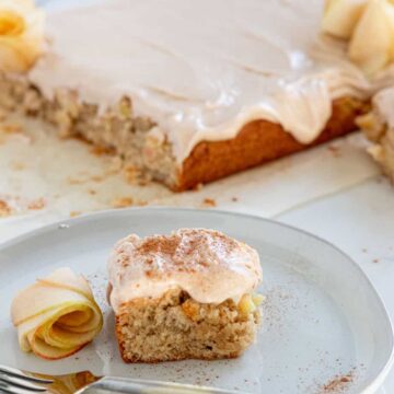 Slice of apple sheet cake on plate with fork