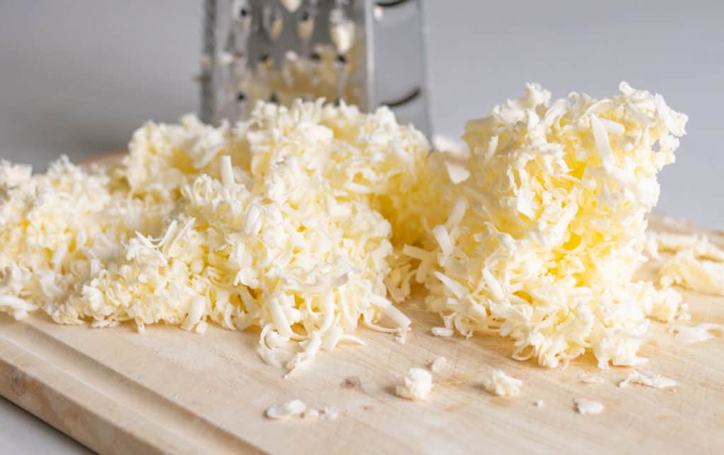 Frozen grated butter for on wood cutting board