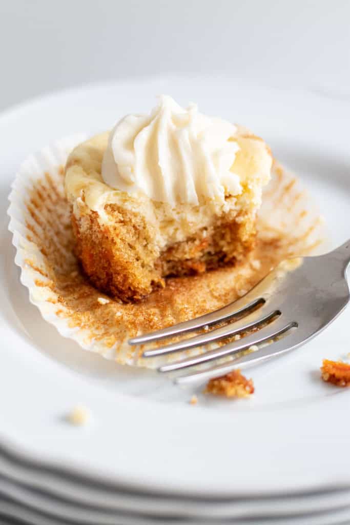 close of up bite out of a carrot cake cheesecake cupcake