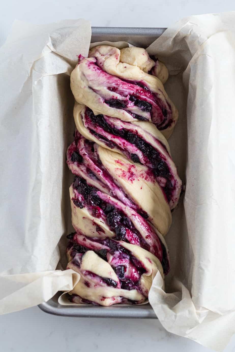 blueberry cream cheese babka in a loaf pan