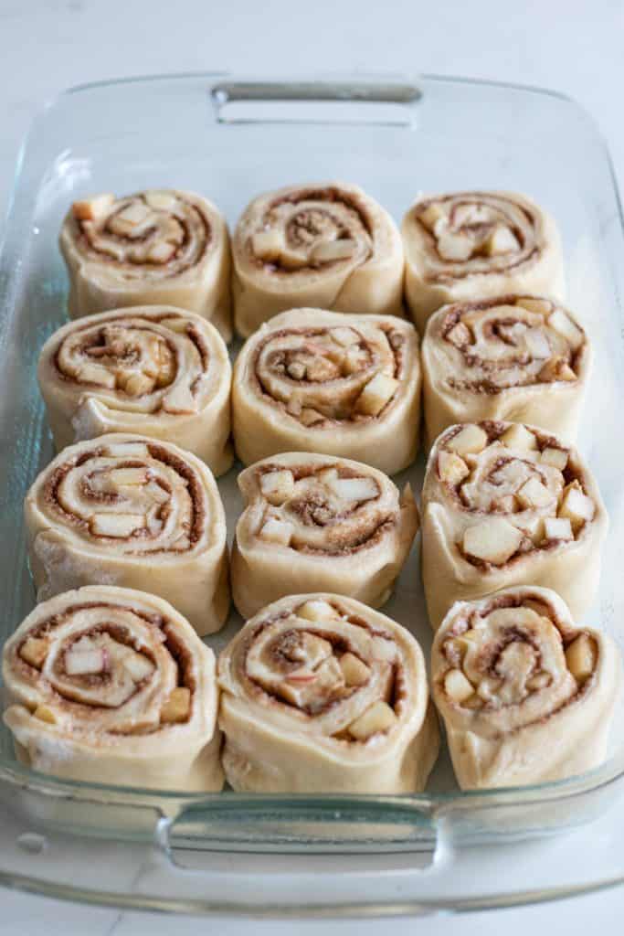 Apple cinnamon rolls in pan to be baked