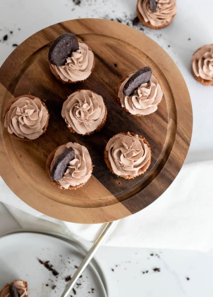 overhead view of mini chocolate cheesecakes on a cake pedestal