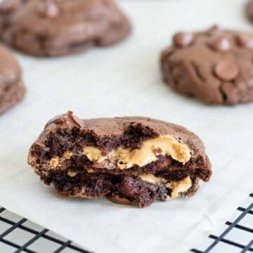 chocolate peanut butter cookie split in half on cooling rack