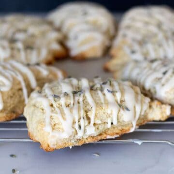 lavender scones glazed with vanilla icing on cooling rack