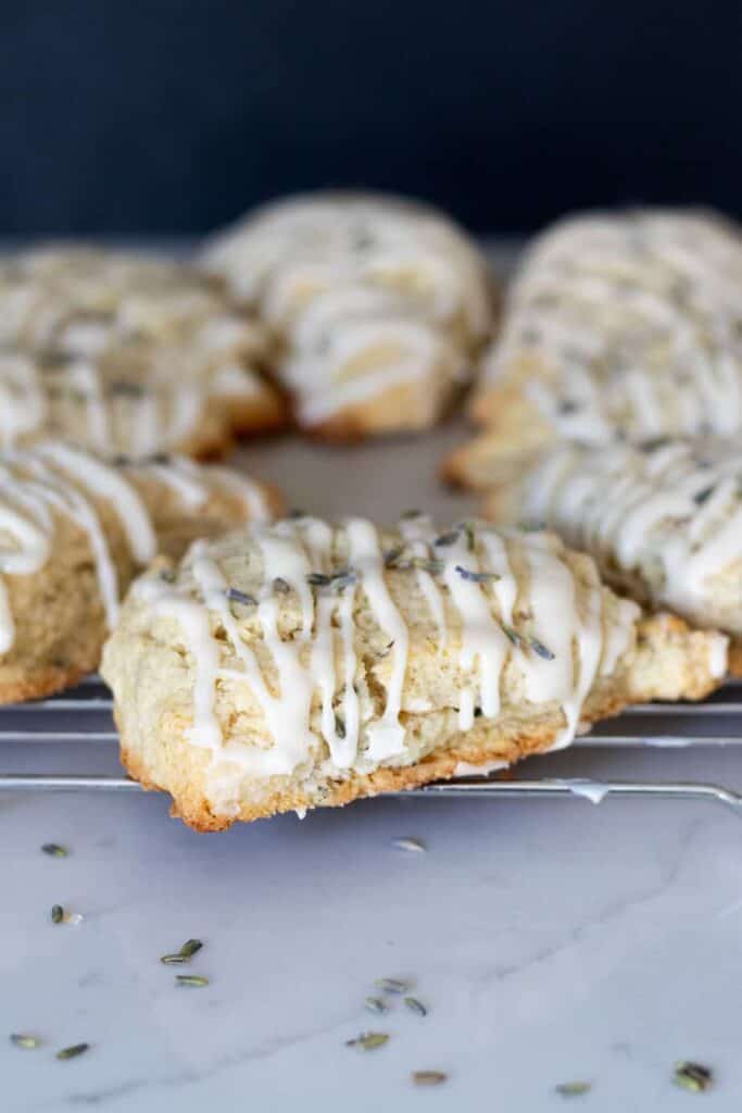 lavender scones glazed with vanilla icing on cooling rack