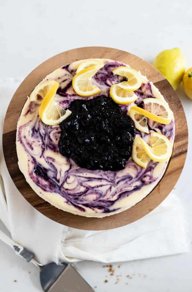 overhead view of lemon blueberry cheesecake on cake stand