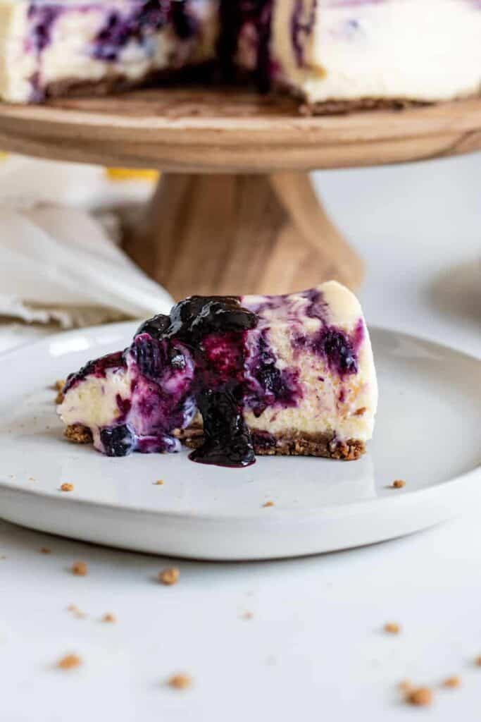 Slice of blueberry lemon cheesecake on plate