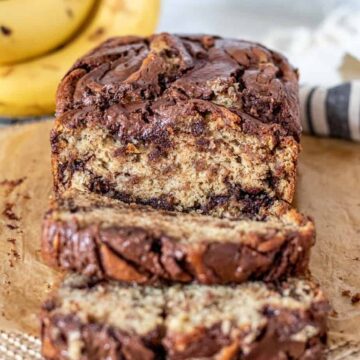 loaf of nutella banana bread with 2 pieces sliced