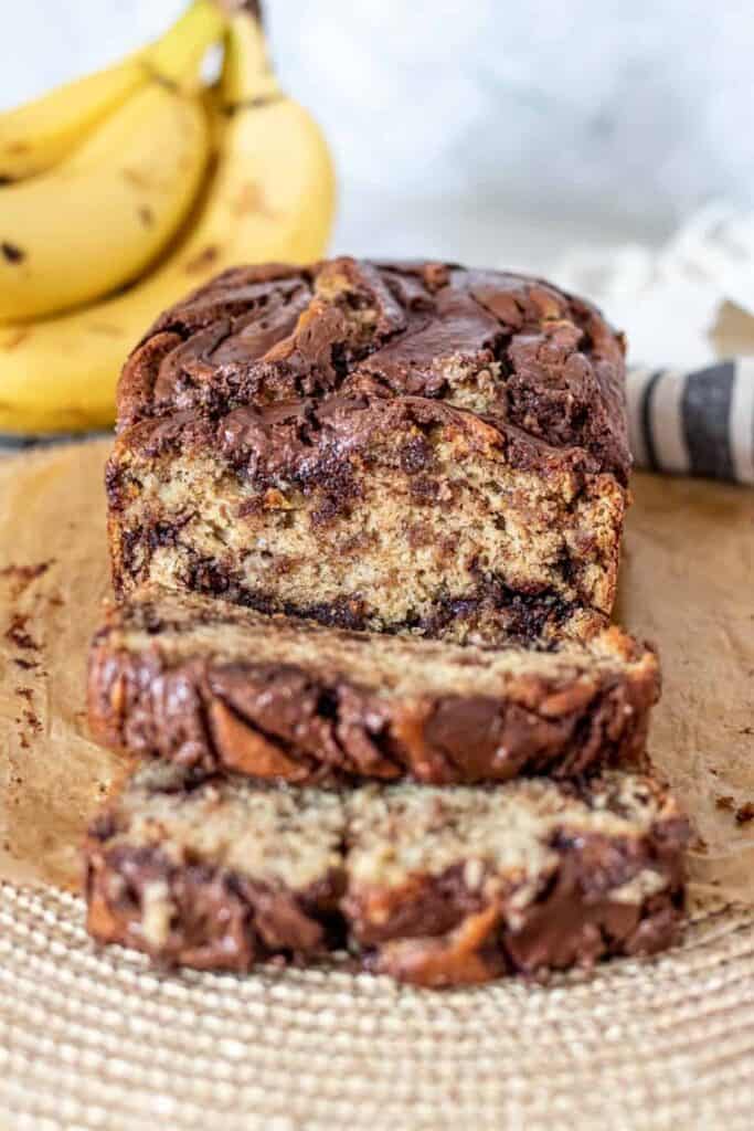 loaf of nutella banana bread with 2 pieces sliced