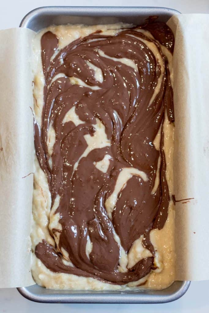 swirls of nutella on top banana bread batter