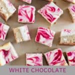 raspberry cheesecake bars scattered on parchment paper