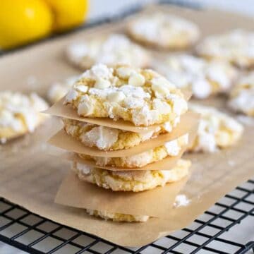 stack of lemon crinkle cookies on cooling rack