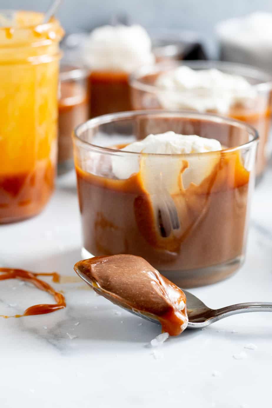 glass cup of chocolate budino with salted caramel and whipped cream