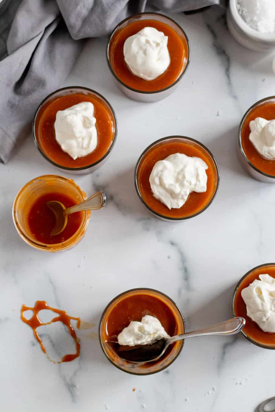 overhead view of chocolate budinos with caramel and whipped cream