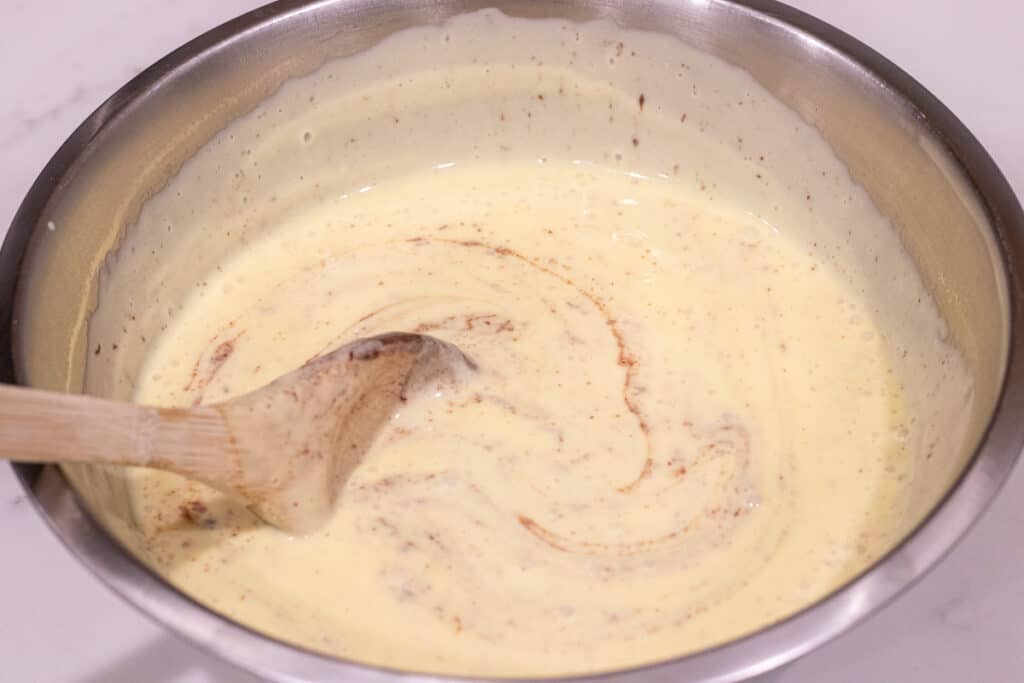 stirring custard and chocolate together in bowl