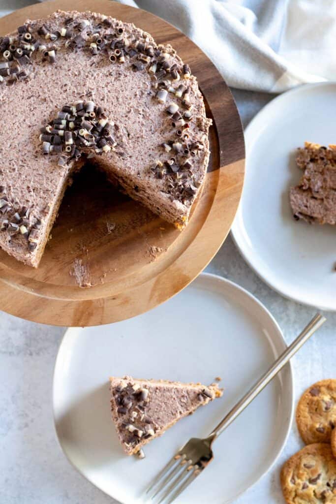 overhead view of cake on wood cake stand with slices on plates