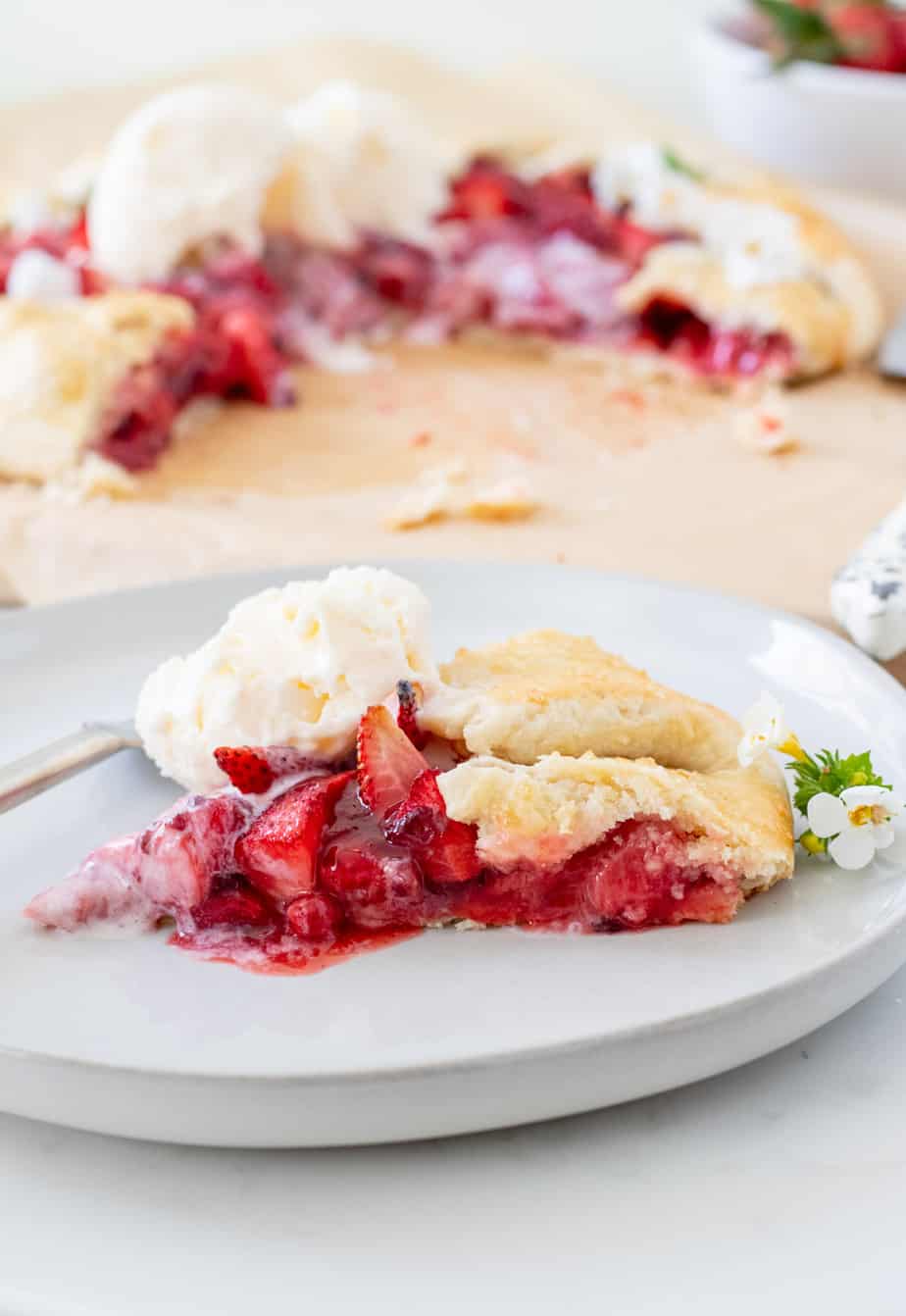 slice of strawberry galette with vanilla ice cream on a plate