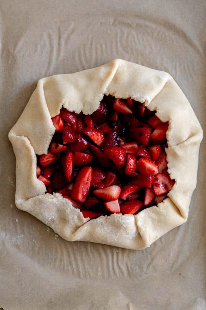 Pie dough folded over strawberries