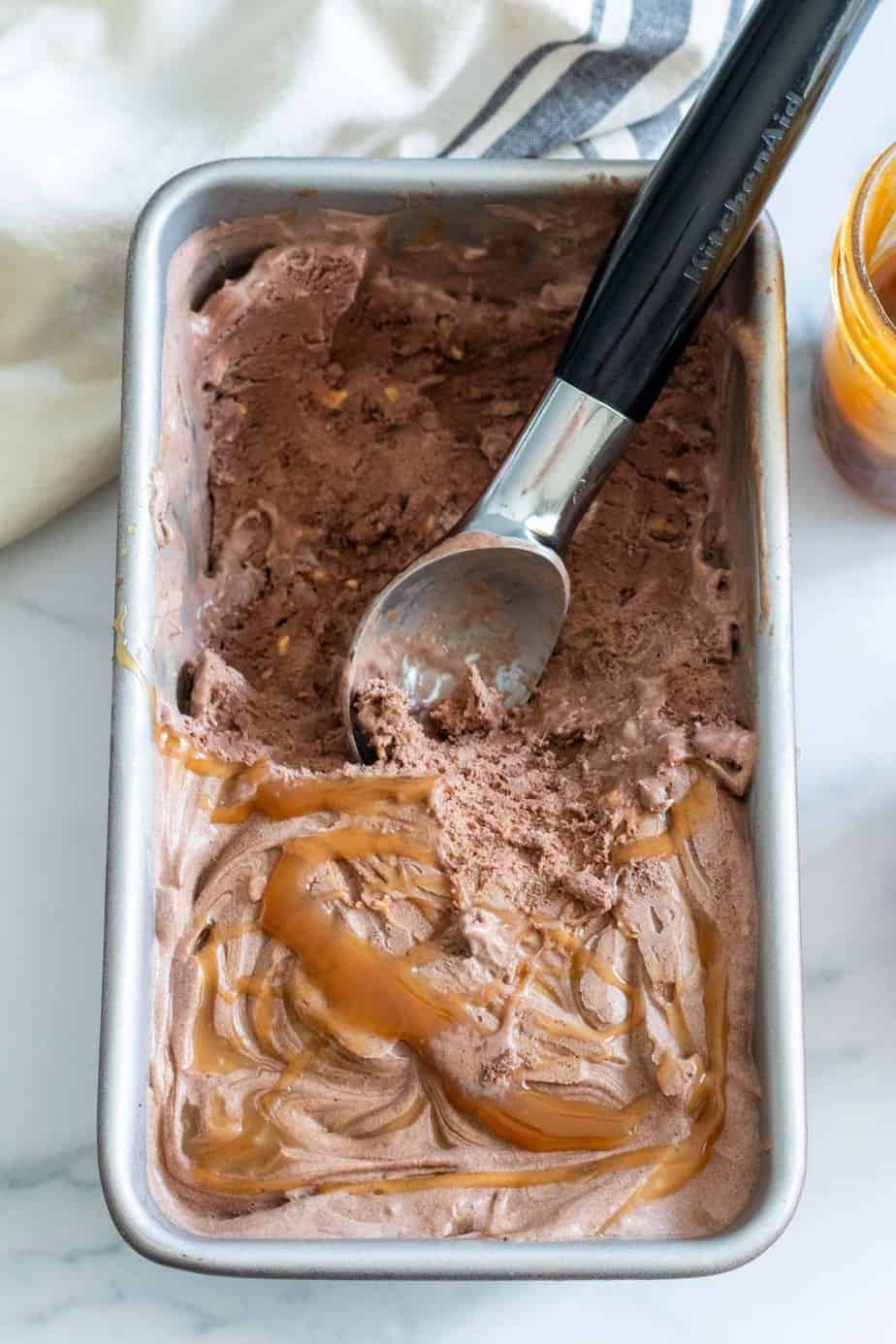 loaf pan of chocolate ice cream with caramel drizzle