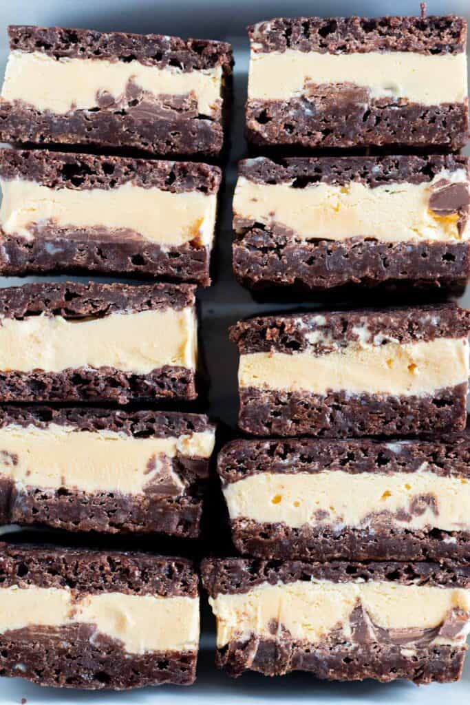 close up of brownie ice cream sandwiches stacked in pan