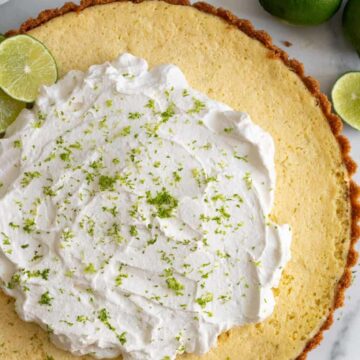 key lime tart with whipped cream and lime zest