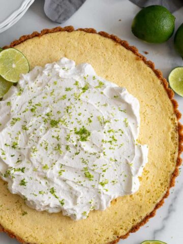 key lime tart with whipped cream and lime zest
