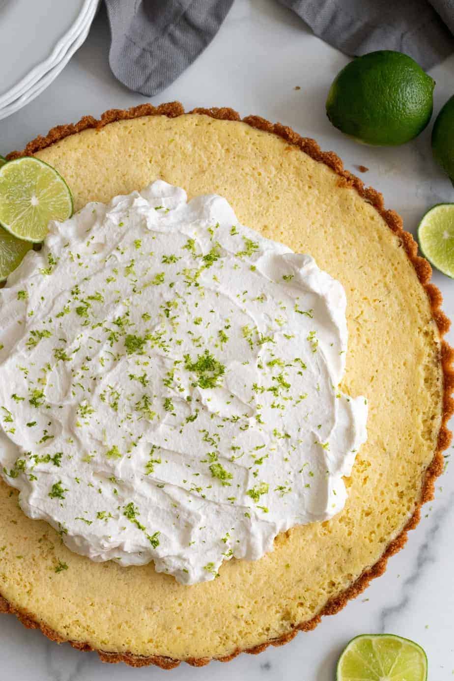 key lime tart with whipped cream and lime zest