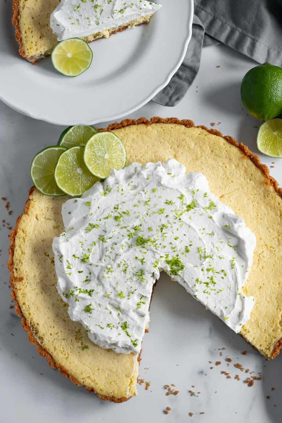 lime tart with slice removed and on plate