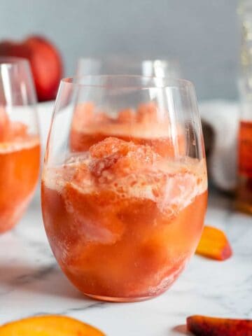 close up of a glass with peach bourbon slush