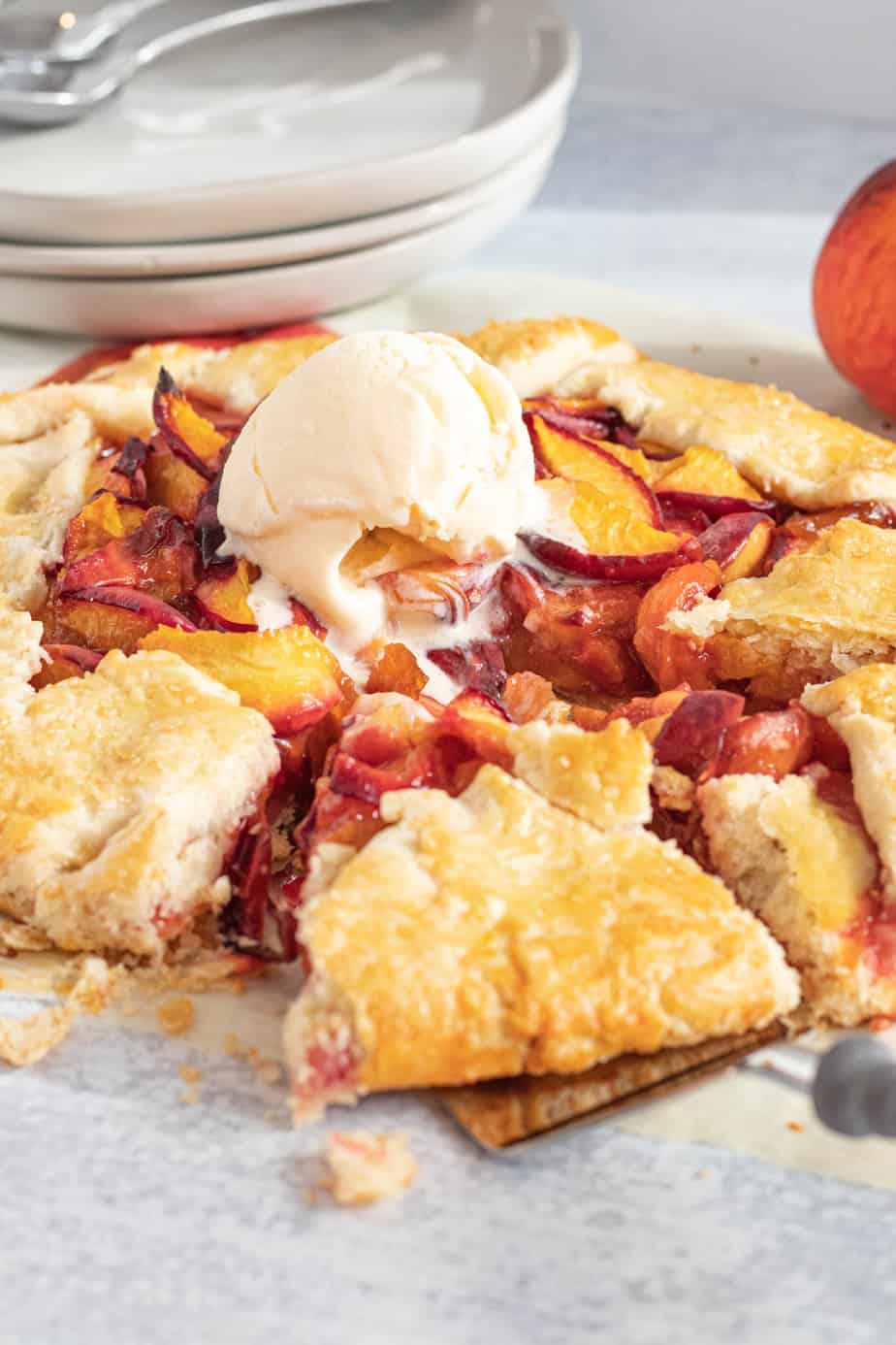 peach galette with scoop of vanilla ice cream