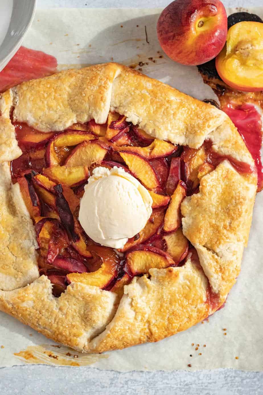 peach galette with vanilla ice cream scoop on top