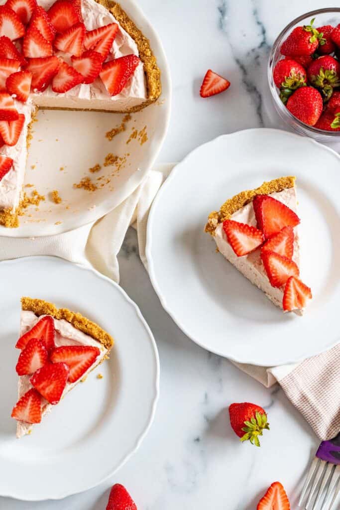 strawberry mousse pie in slices on white plates