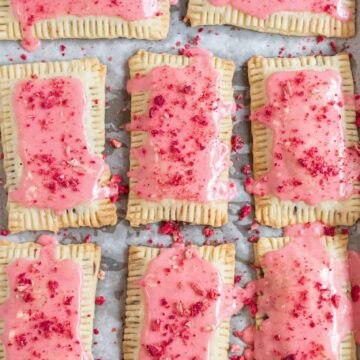 pop tarts with strawberry glaze on baking sheet