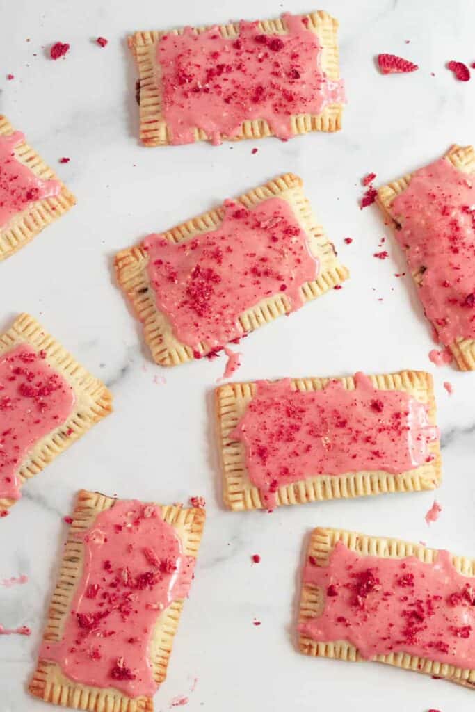 chocolate pop tarts with strawberry glaze on a white marble counter