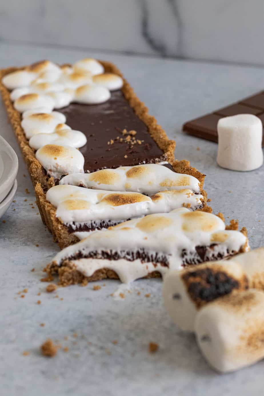 triangle shaped slices of s'mores tart with toasted marshmallow on top