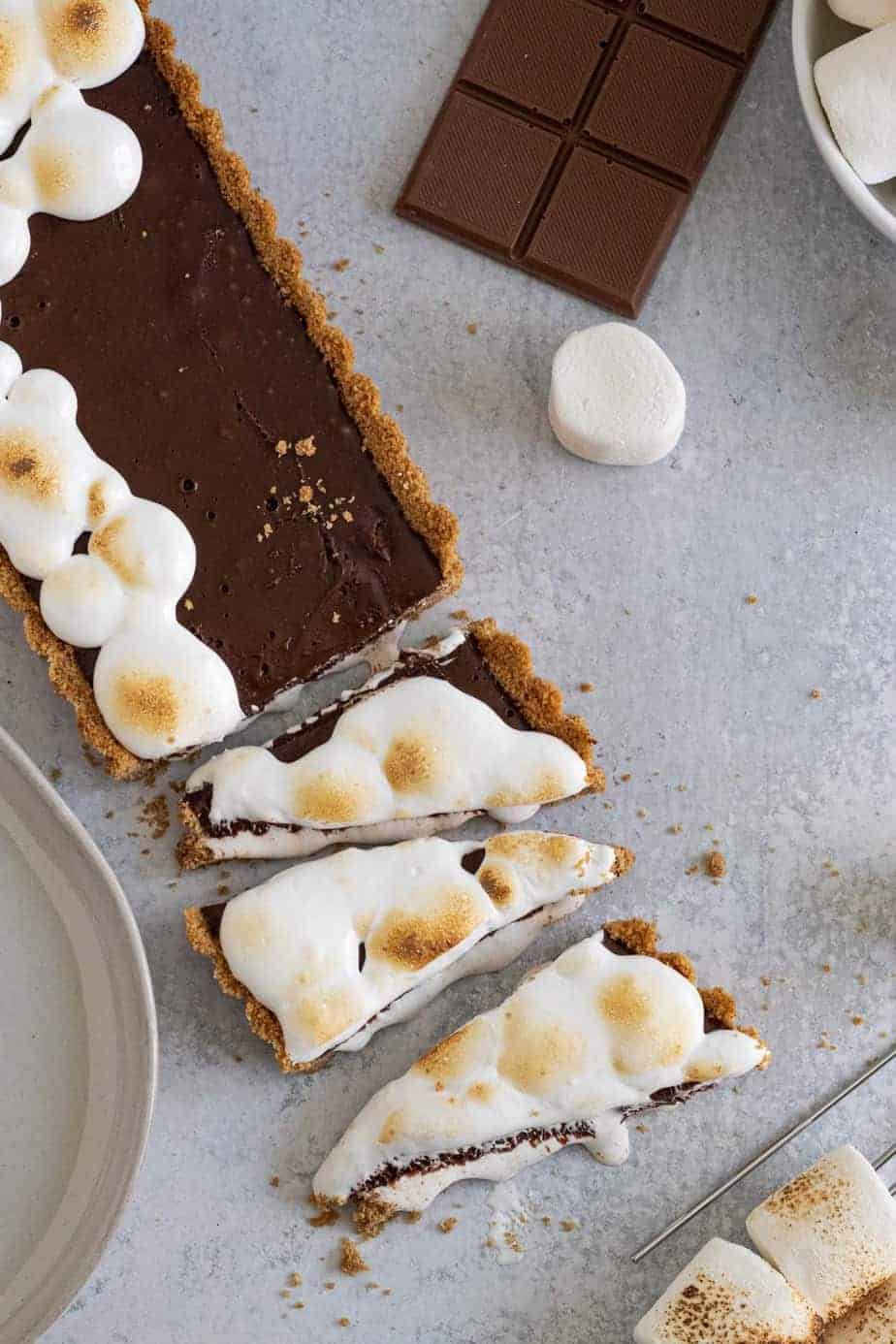 rectangle chocolate tart cut into triangles with toasted marshmallow on top