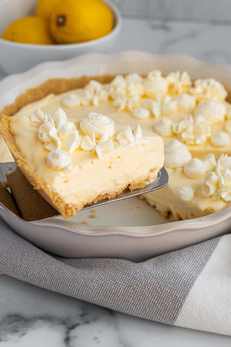 slice of lemon pie on spatula being lifted from pie plate