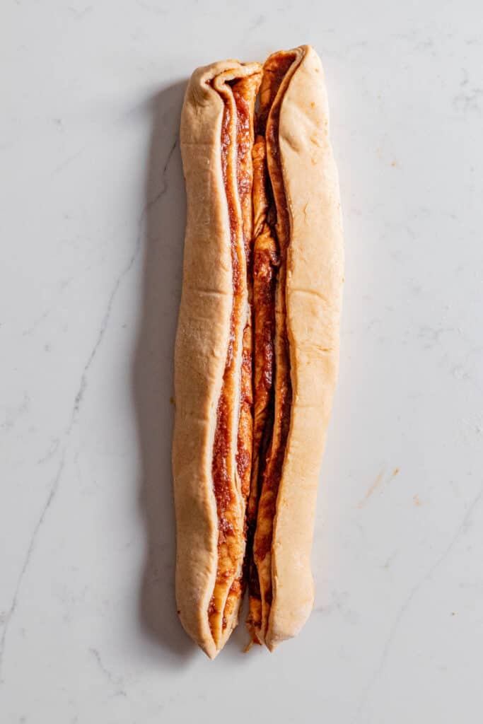 babka dough cut down the middle lengthwise exposing apple cinnamon filling