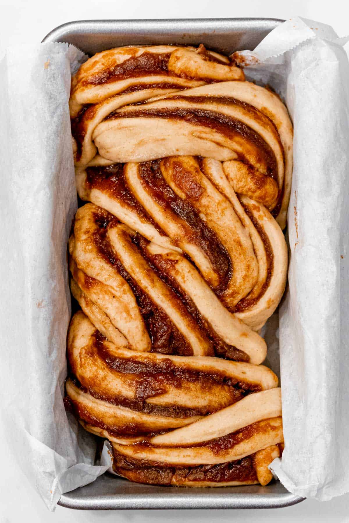 apple cinnamon babka dough in a loaf pan after rising