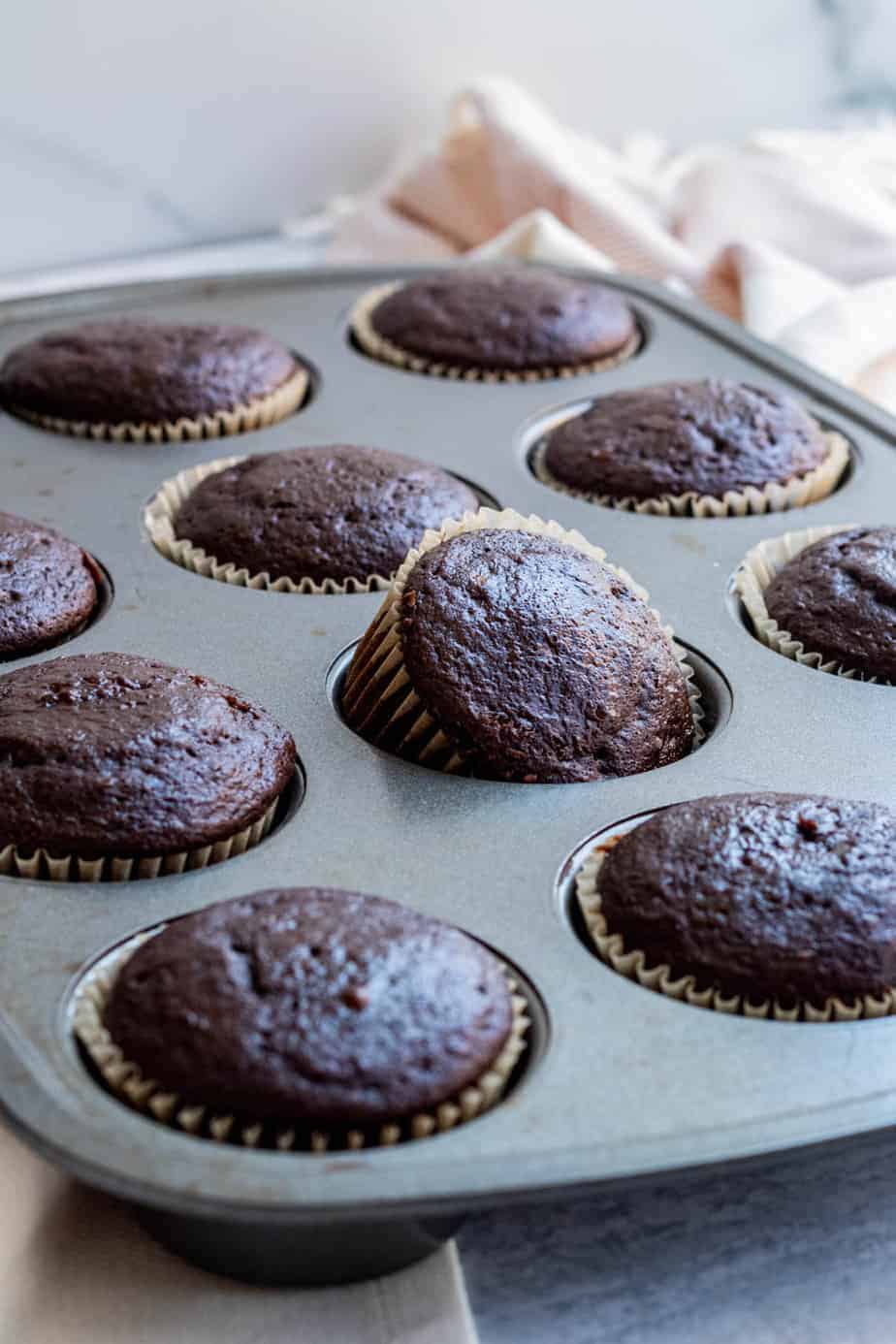 cupcake pan with baked chocolate cupcakes