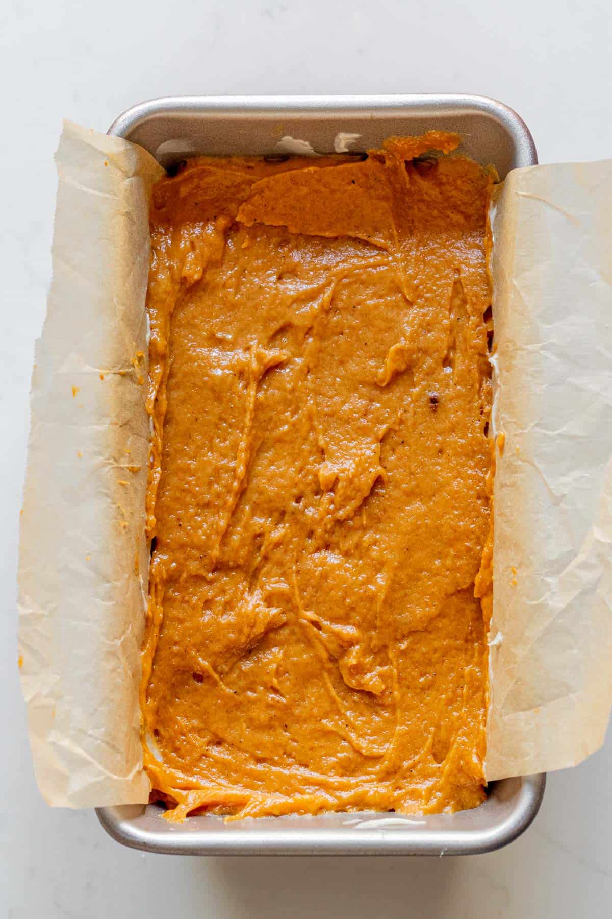 pumpkin bread batter in a loaf pan