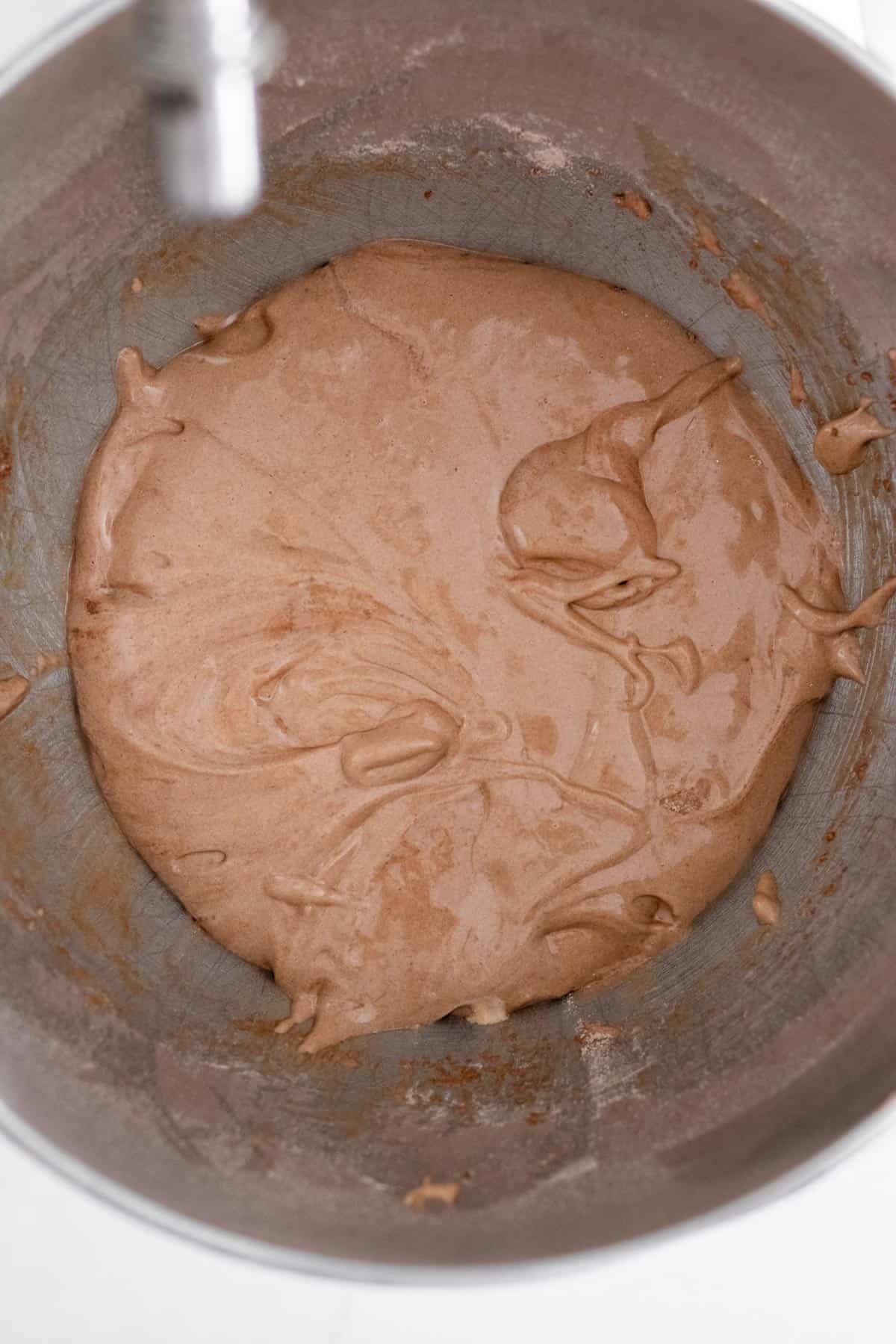 chocolate madeleine batter in a mixing bowl