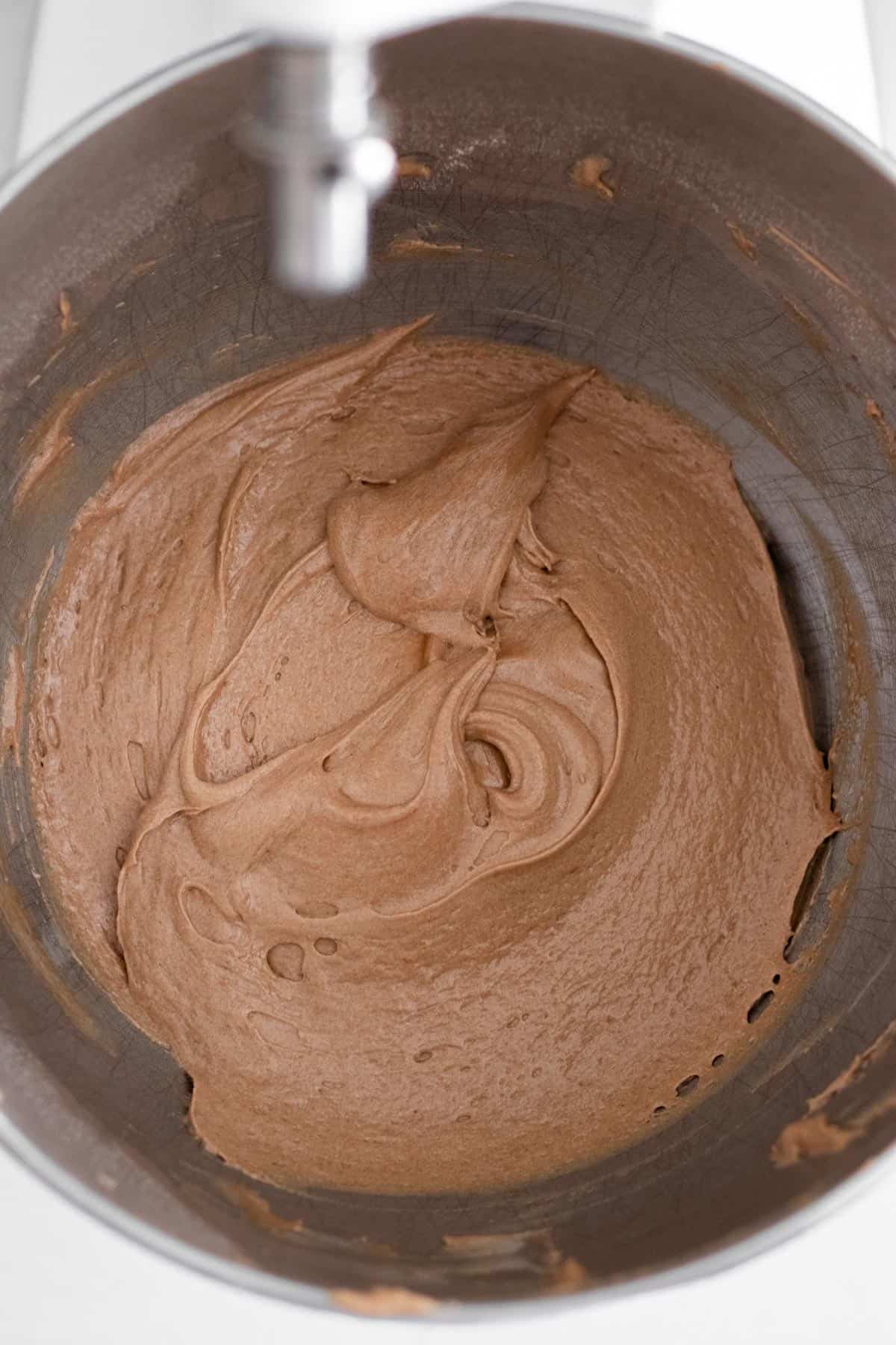 chocolate madeleine batter in a mixing bowl