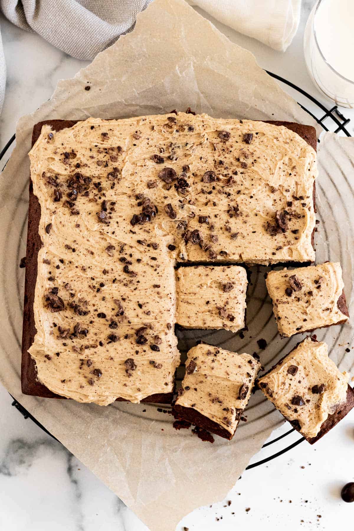 top view of pan of brownies with espresso frosting and 4 brownies cut