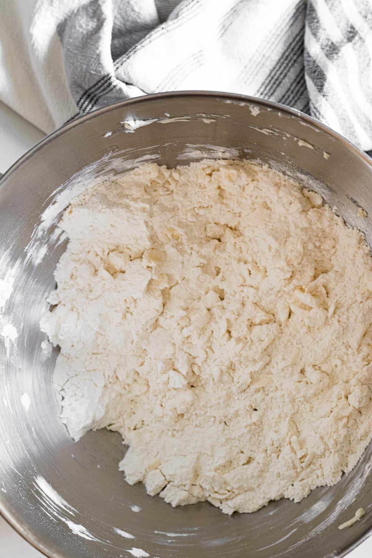 flour and grated butter mixed together in a silver mixing bowl